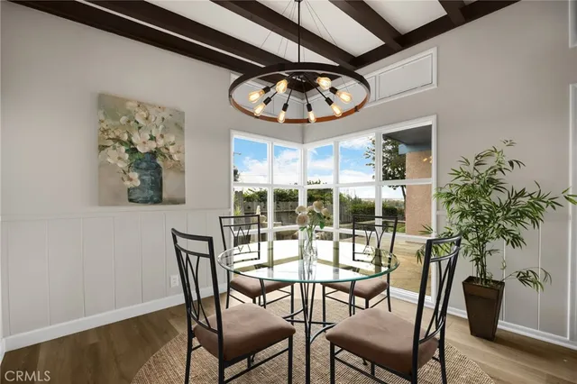 a view of a dining room with furniture window and wooden floor