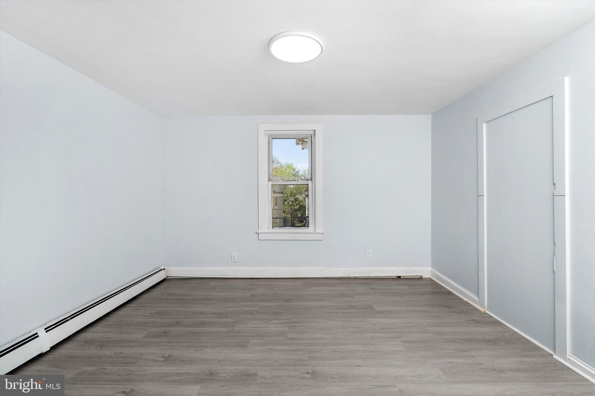 10 Lytle Street, Unit 4 Princeton, NJ 08542 - Photo 11 of 17 an empty room with wooden floor and windows