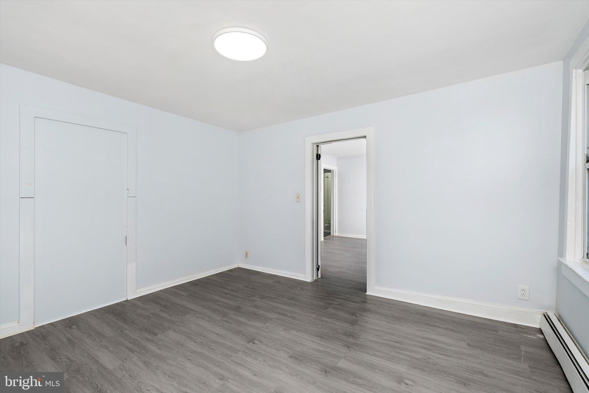 10 Lytle Street, Unit 4 Princeton, NJ 08542 - Photo 12 of 17 a view of an empty room with wooden floor and a window