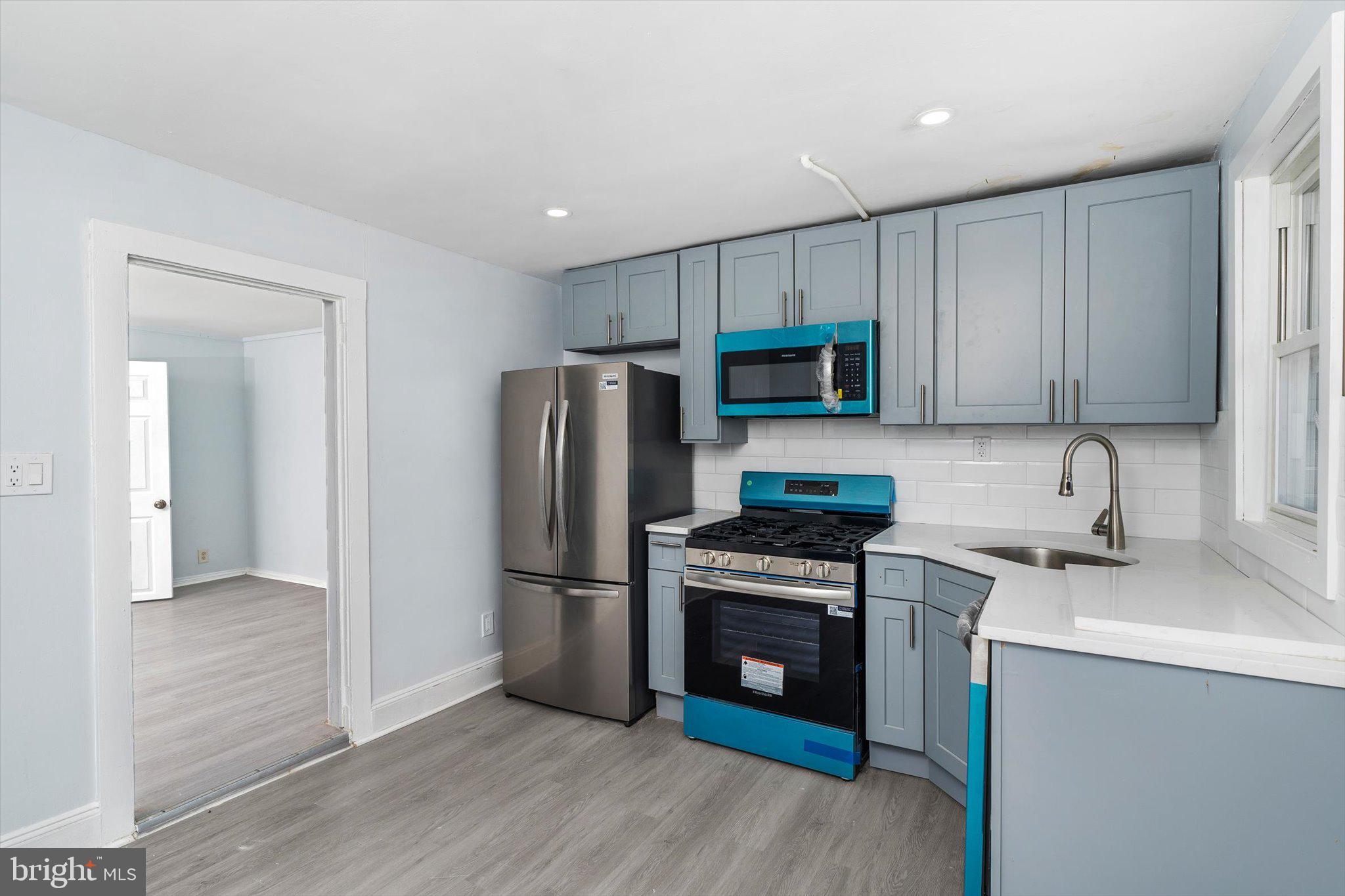 10 Lytle Street, Unit 4 Princeton, NJ 08542 - Photo 7 of 17 a kitchen with a sink a refrigerator and cabinets