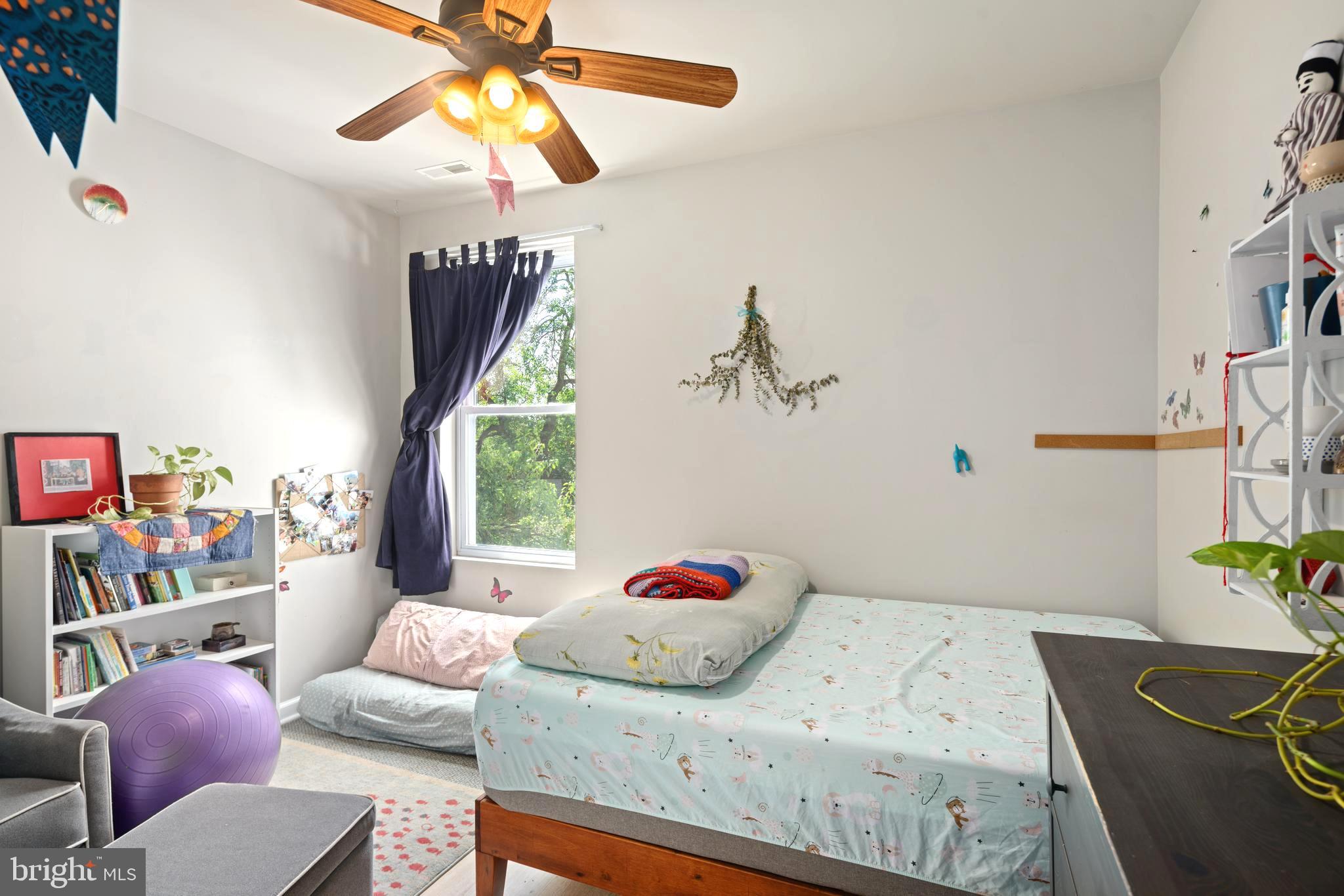 4804 Kingsessing Avenue Philadelphia, PA 19143 - Photo 11 of 17 a bedroom with a bed and a chandelier