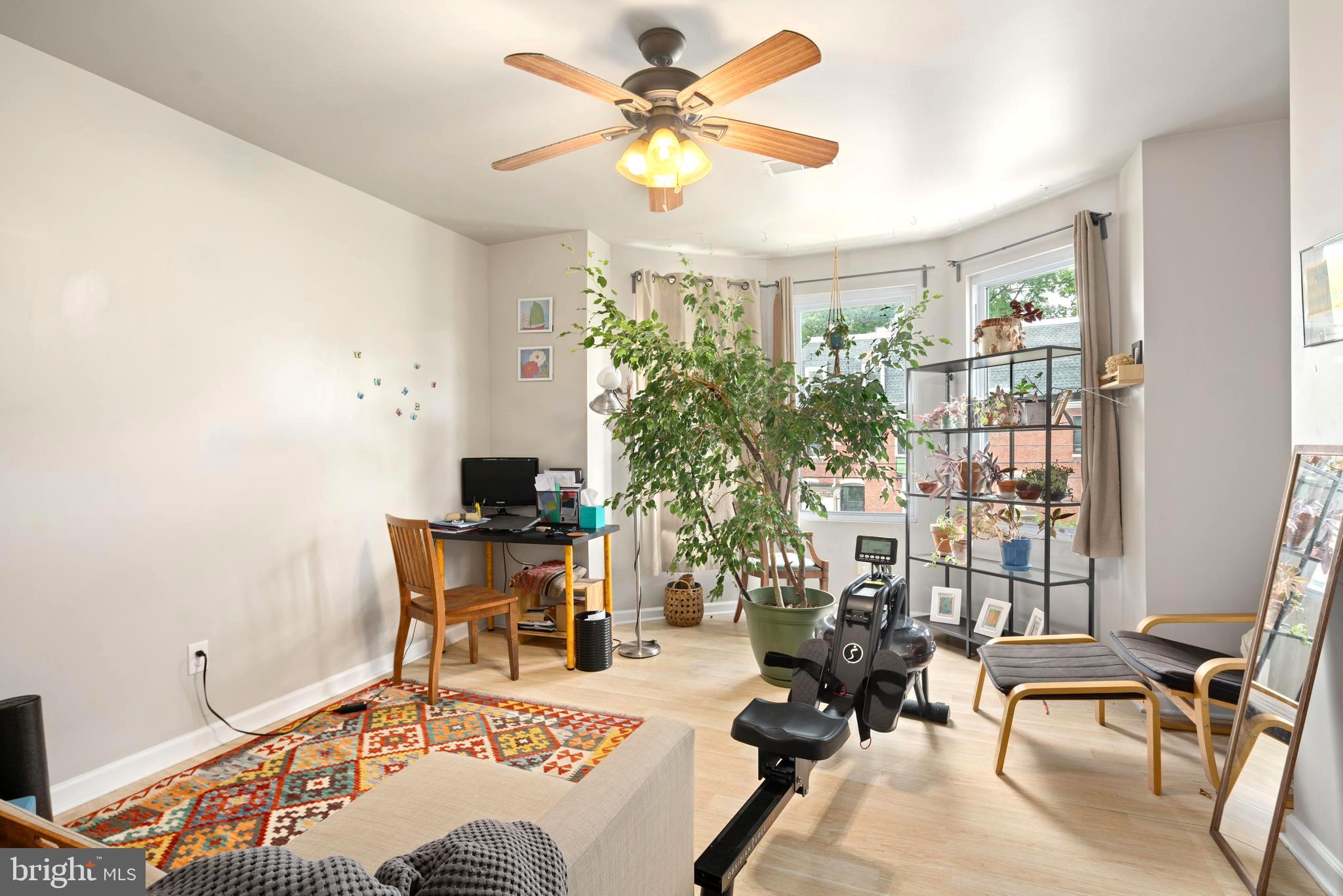 4804 Kingsessing Avenue Philadelphia, PA 19143 - Photo 15 of 17 a living room with furniture a chandelier and a window