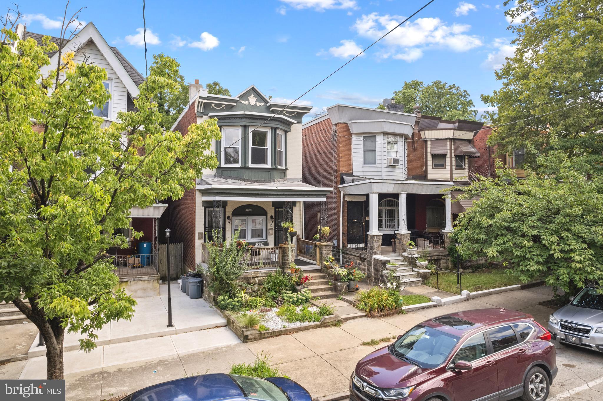 4804 Kingsessing Avenue Philadelphia, PA 19143 - Photo 2 of 17 a front view of a house with yard and outdoor seating
