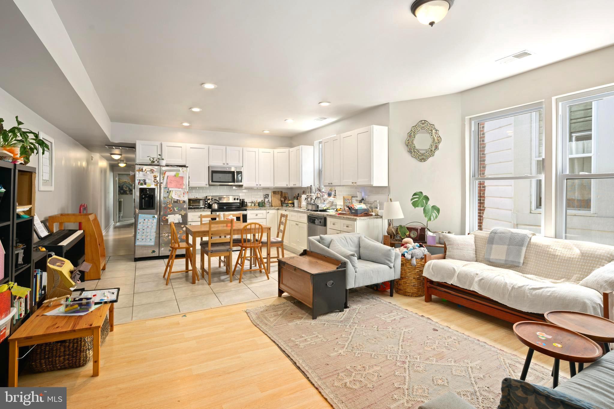 4804 Kingsessing Avenue Philadelphia, PA 19143 - Photo 6 of 17 a living room with lots of furniture and a large window