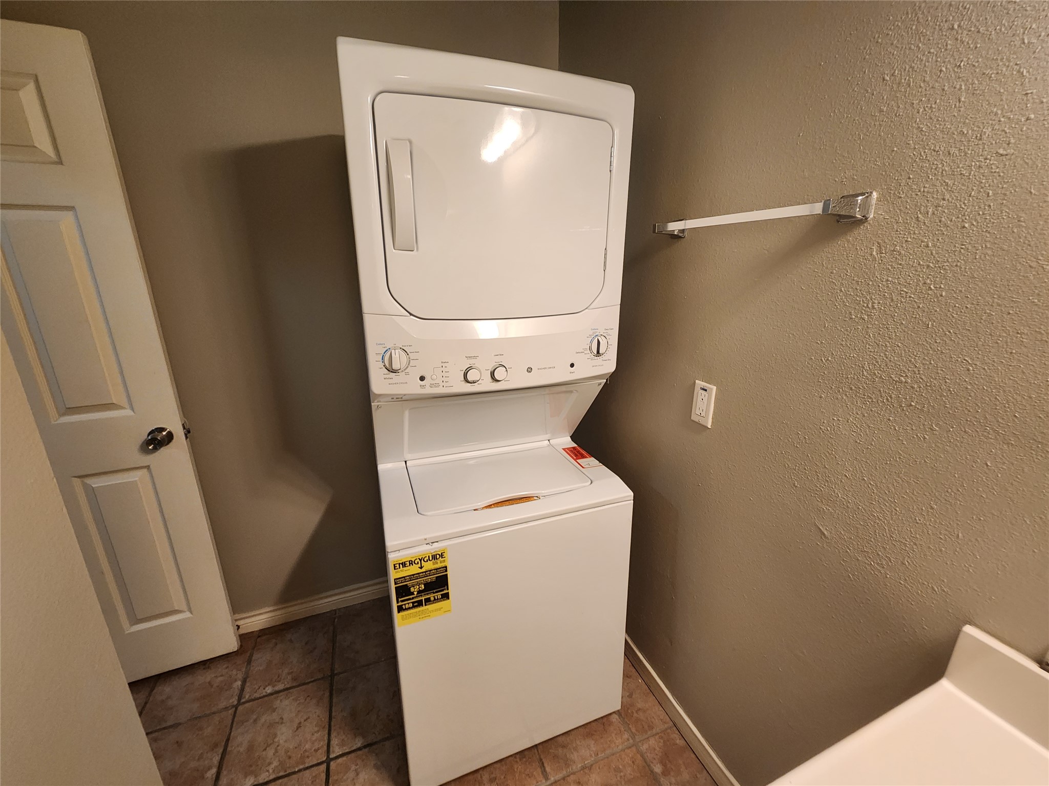 2714 Whitis Avenue, Unit ABC Austin, TX 78705 - Photo 20 of 24 Washroom with stacked washer and clothes dryer, tile patterned flooring, and a textured wall