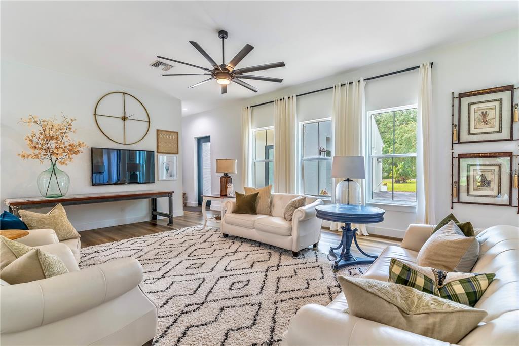 31035 Pasco Road San Antonio, FL 33576 - Photo 14 of 80 a living room with furniture a fireplace and a large window