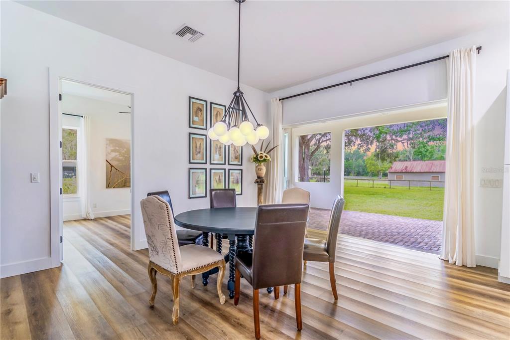 31035 Pasco Road San Antonio, FL 33576 - Photo 15 of 80 a view of a dining room with furniture window and wooden floor