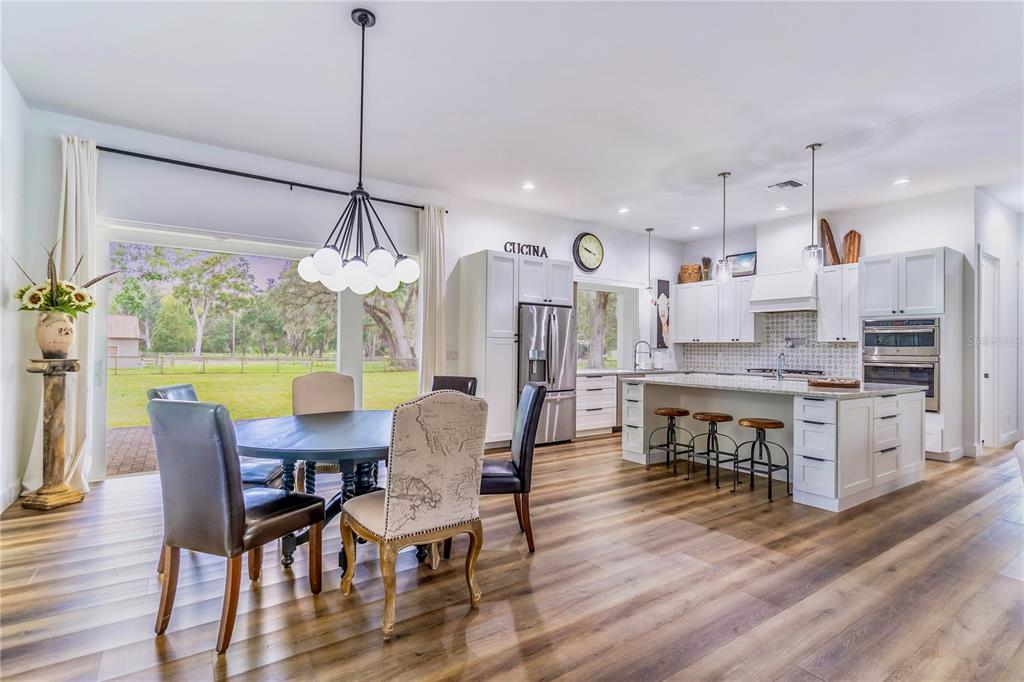 31035 Pasco Road San Antonio, FL 33576 - Photo 16 of 80 a view of a dining room with furniture window and wooden floor