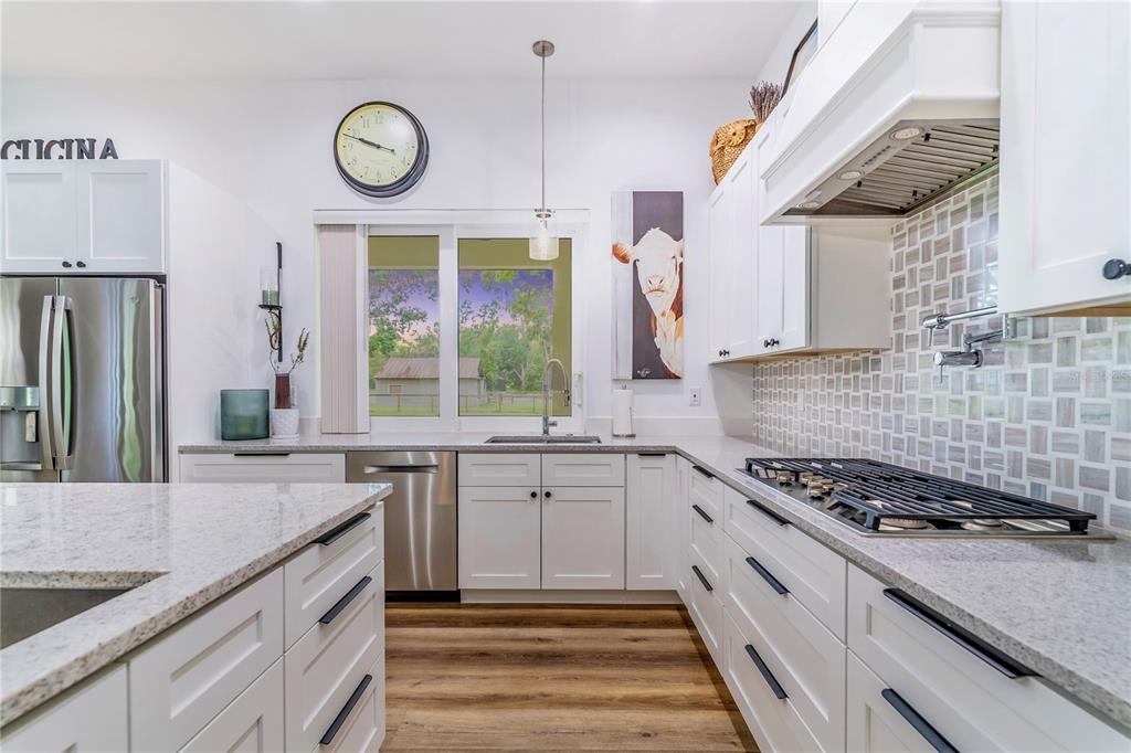 31035 Pasco Road San Antonio, FL 33576 - Photo 18 of 80 a kitchen with stainless steel appliances granite countertop a stove and a sink