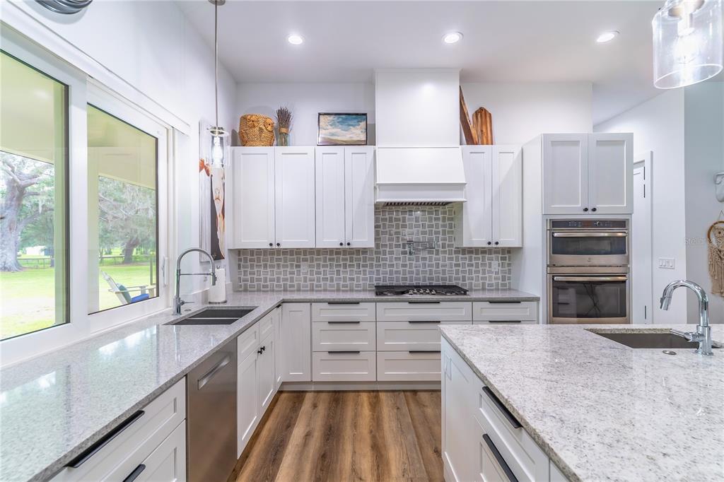 31035 Pasco Road San Antonio, FL 33576 - Photo 19 of 80 a kitchen with stainless steel appliances granite countertop a sink and a stove