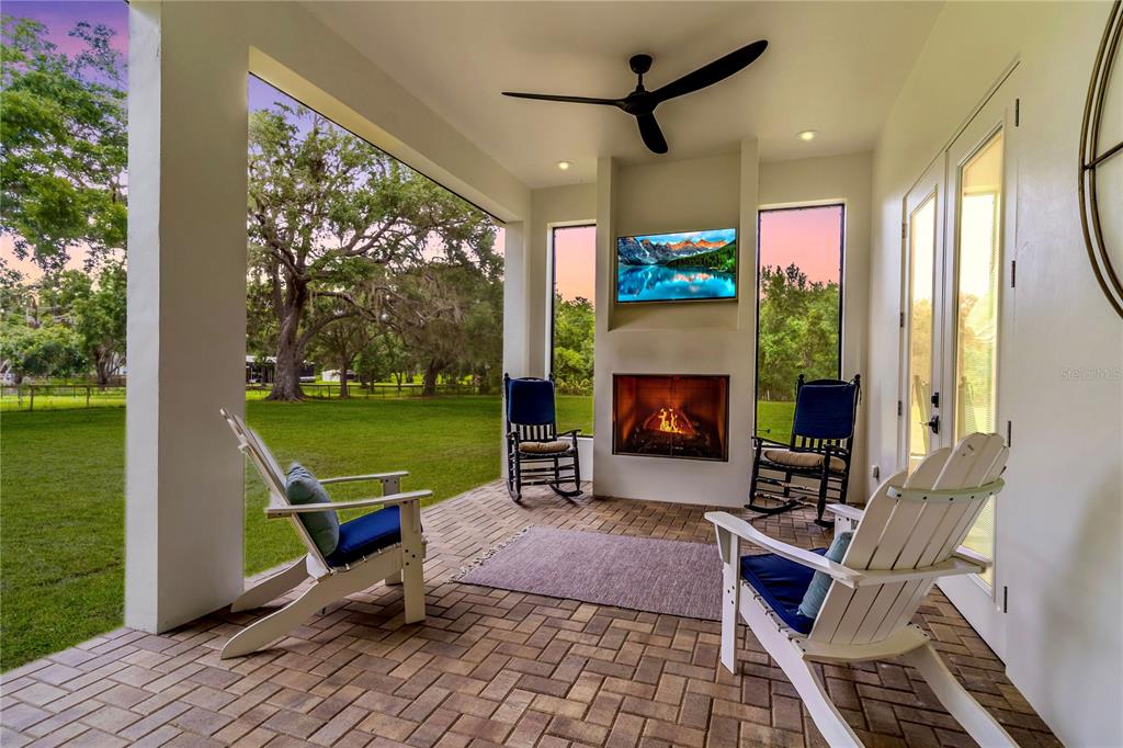 31035 Pasco Road San Antonio, FL 33576 - Photo 2 of 80 a building outdoor space with patio furniture and a fireplace