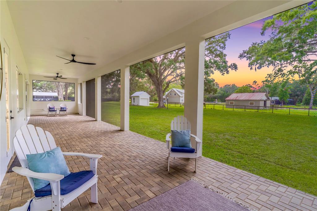 31035 Pasco Road San Antonio, FL 33576 - Photo 3 of 80 a view of a patio with dining table and chairs swing