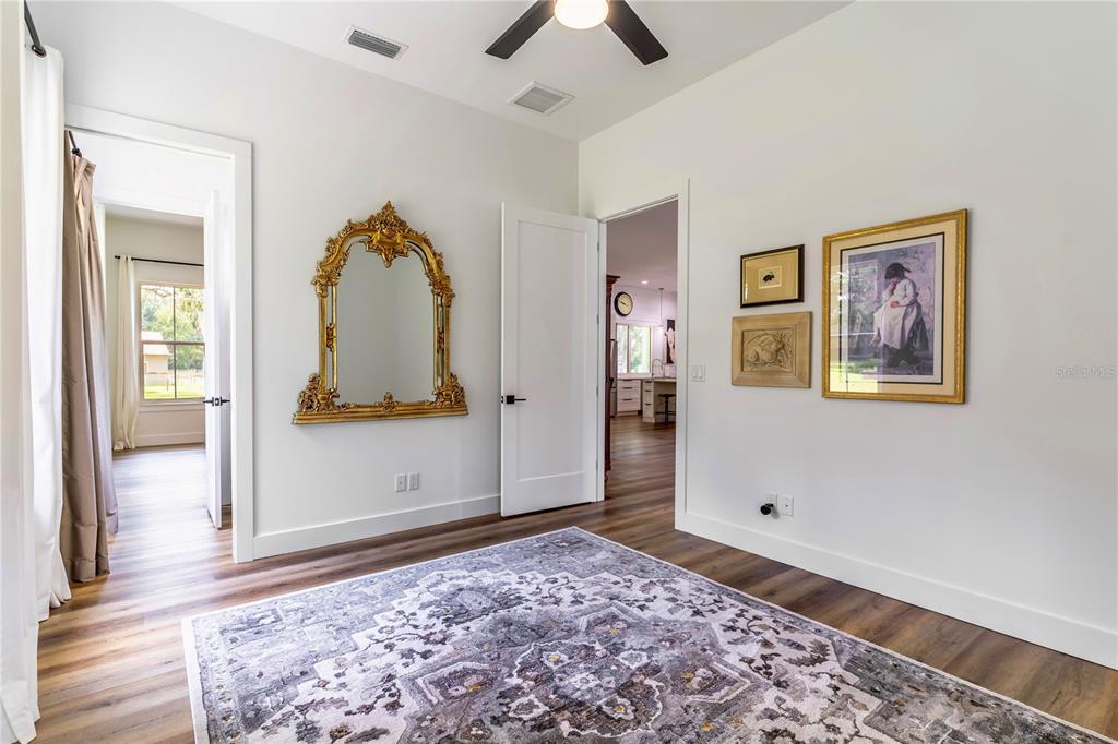 31035 Pasco Road San Antonio, FL 33576 - Photo 33 of 80 a view of a bedroom with wooden floor and ceiling fan