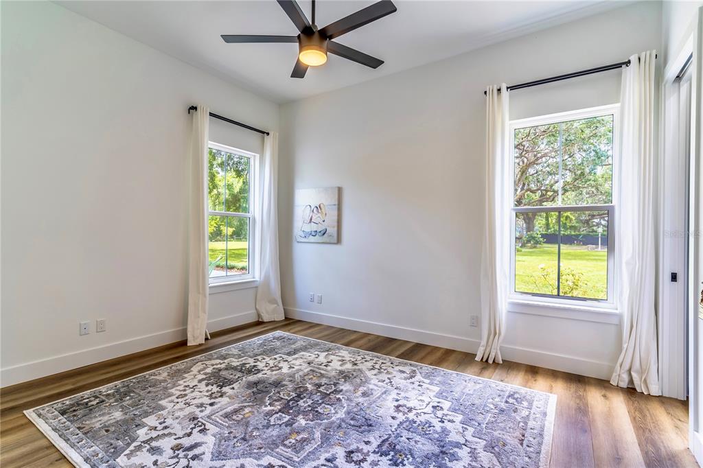 31035 Pasco Road San Antonio, FL 33576 - Photo 36 of 80 an empty room with window and a ceiling fan