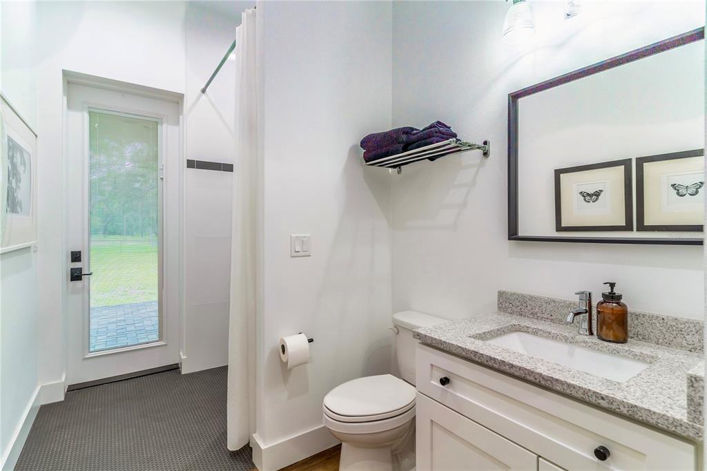 31035 Pasco Road San Antonio, FL 33576 - Photo 38 of 80 a bathroom with a granite countertop sink toilet and shower