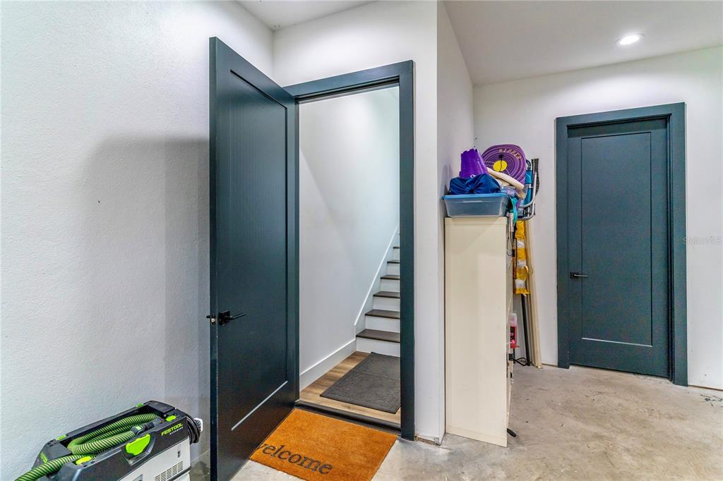 31035 Pasco Road San Antonio, FL 33576 - Photo 41 of 80 a view of a hallway to room with wooden floor and stairs