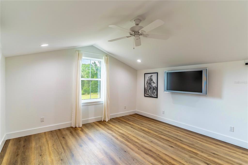 31035 Pasco Road San Antonio, FL 33576 - Photo 46 of 80 an empty room with wooden floor and windows