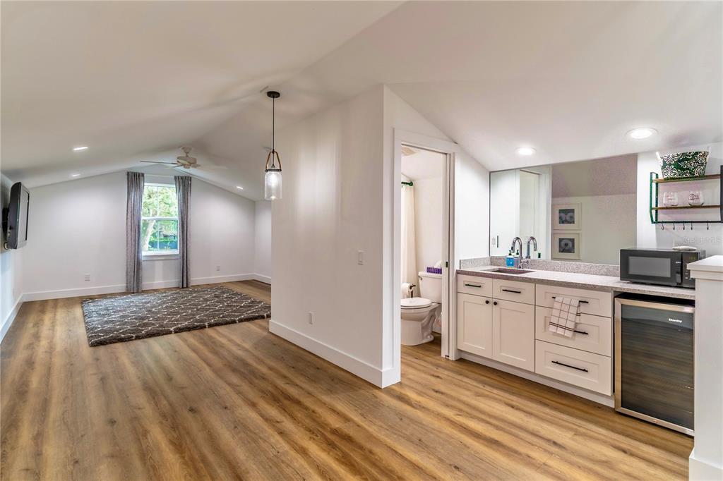 31035 Pasco Road San Antonio, FL 33576 - Photo 49 of 80 a spacious bathroom with a granite countertop sink a mirror and a toilet