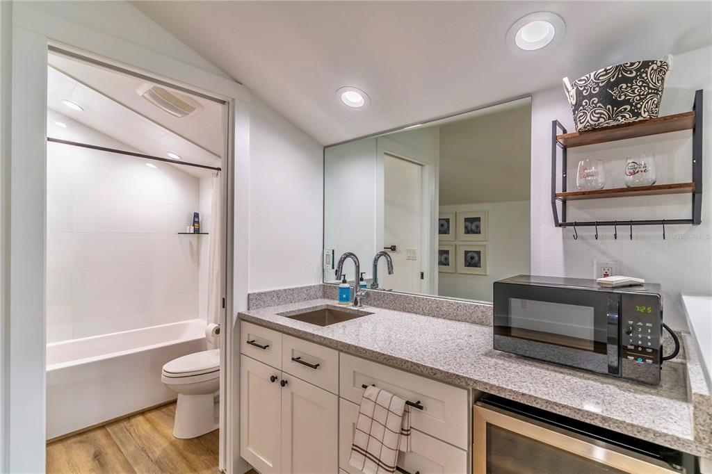31035 Pasco Road San Antonio, FL 33576 - Photo 50 of 80 a bathroom with a granite countertop sink toilet and shower