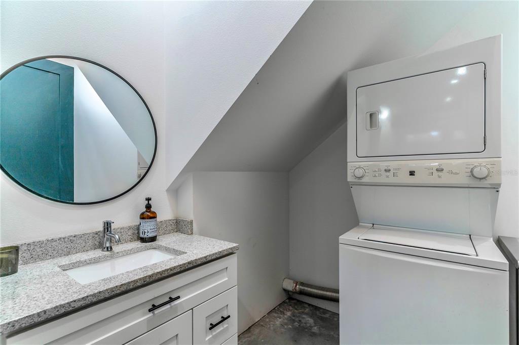 31035 Pasco Road San Antonio, FL 33576 - Photo 52 of 80 a bathroom with a granite countertop toilet sink mirror and vanity