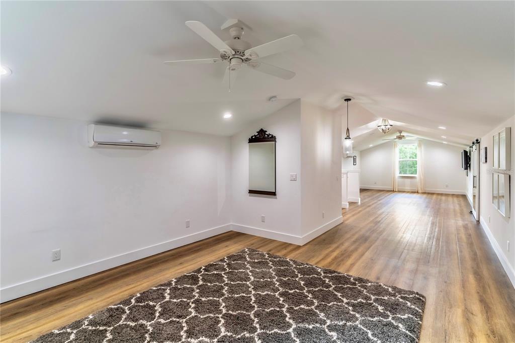 31035 Pasco Road San Antonio, FL 33576 - Photo 55 of 80 an empty room with wooden floor and a ceiling fan