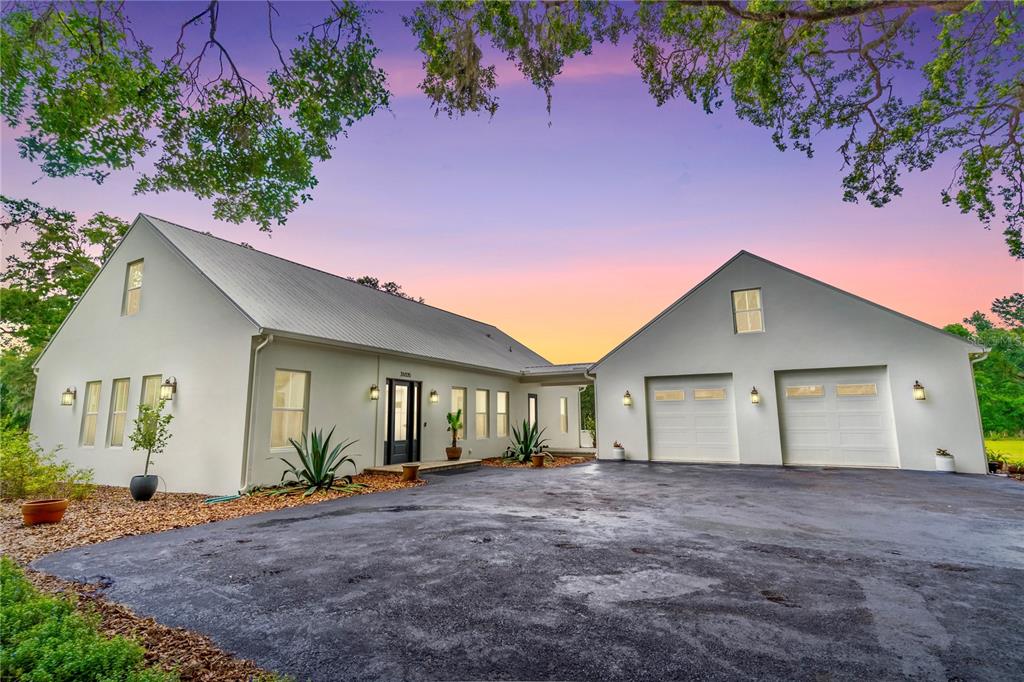31035 Pasco Road San Antonio, FL 33576 - Photo 6 of 80 a view of a house with a yard and garage