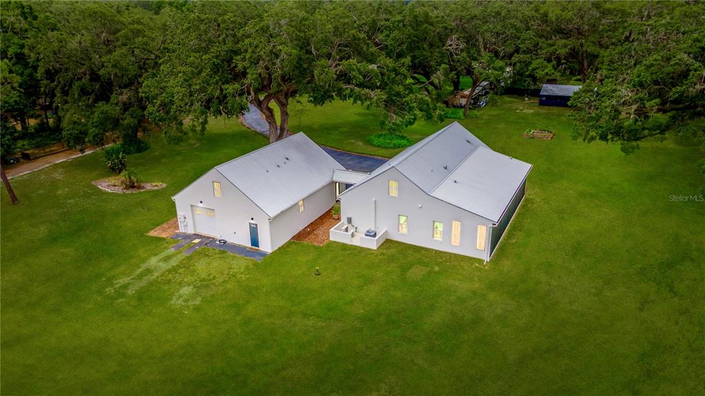 31035 Pasco Road San Antonio, FL 33576 - Photo 65 of 80 an aerial view of a house with garden space and a street view