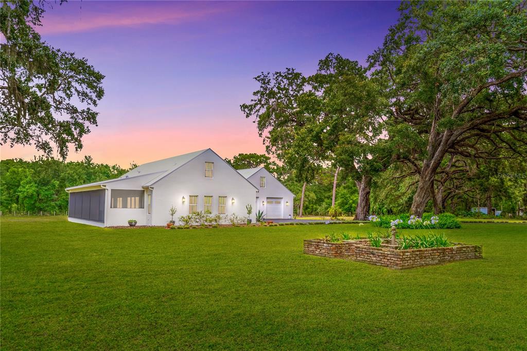 31035 Pasco Road San Antonio, FL 33576 - Photo 72 of 80 a front view of a house with garden