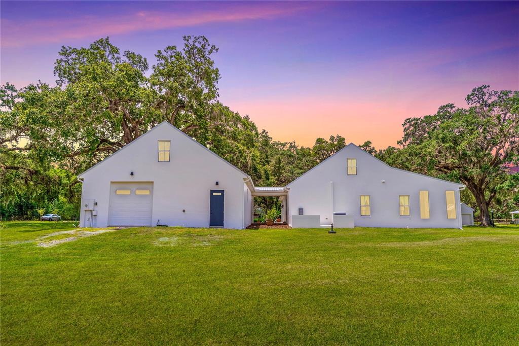 31035 Pasco Road San Antonio, FL 33576 - Photo 78 of 80 a front view of house with yard and trees in the background