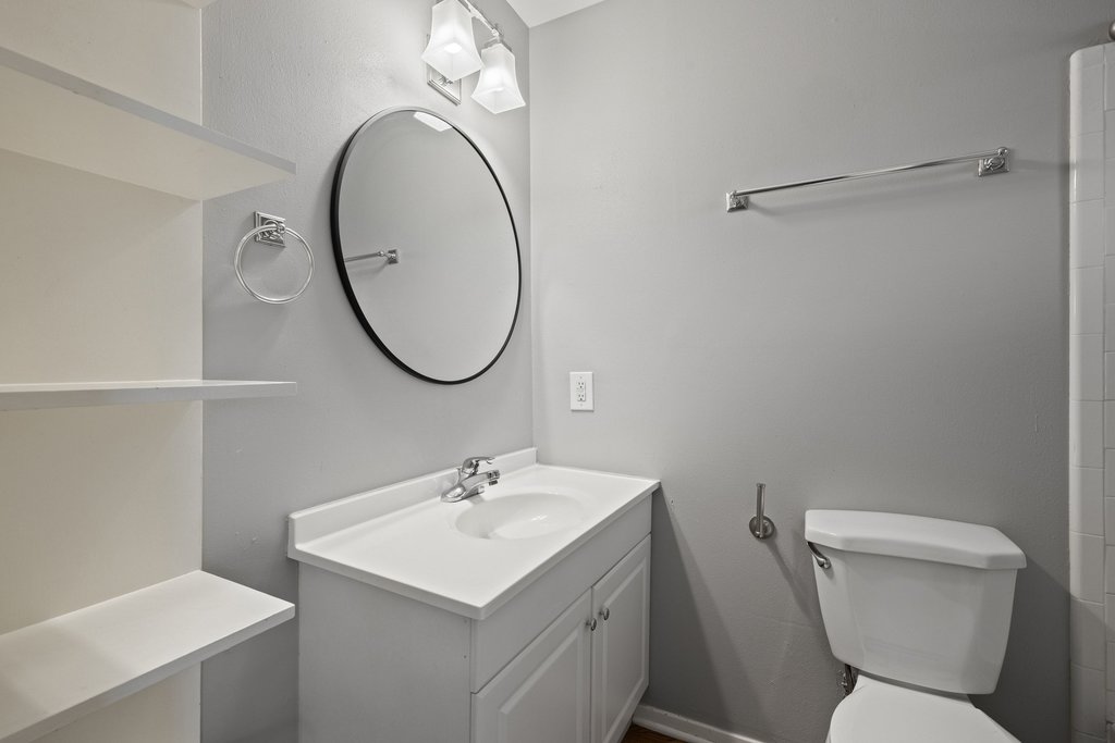 1210 Windsor Road, Unit 209 Austin, TX 78703 - Photo 16 of 38 To complete the primary suite, an ensuite bath offers a modern vanity and mirror.