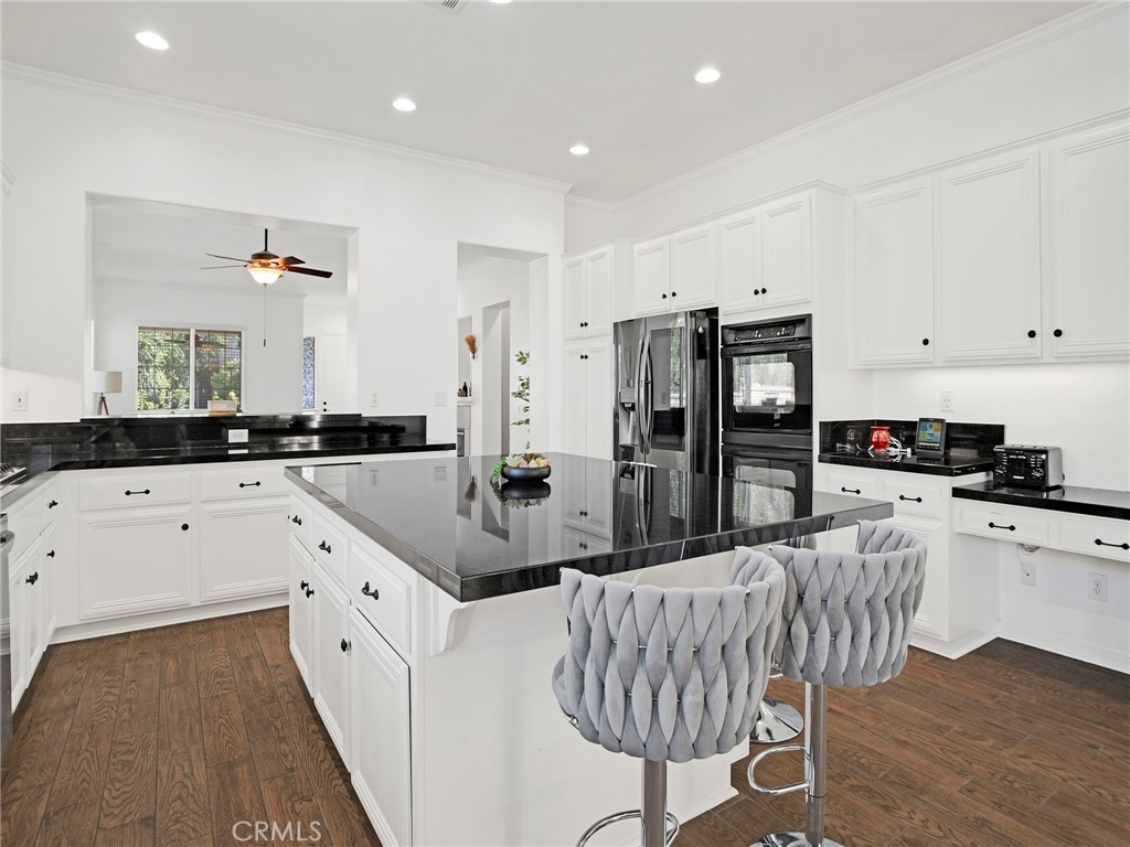 21103 Cross Creek Drive Saugus, CA 91350 - Photo 12 of 41 a large kitchen with kitchen island a large counter top space and stainless steel appliances