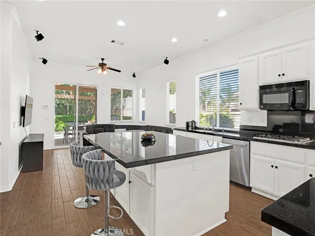 a kitchen with sink stove and cabinets