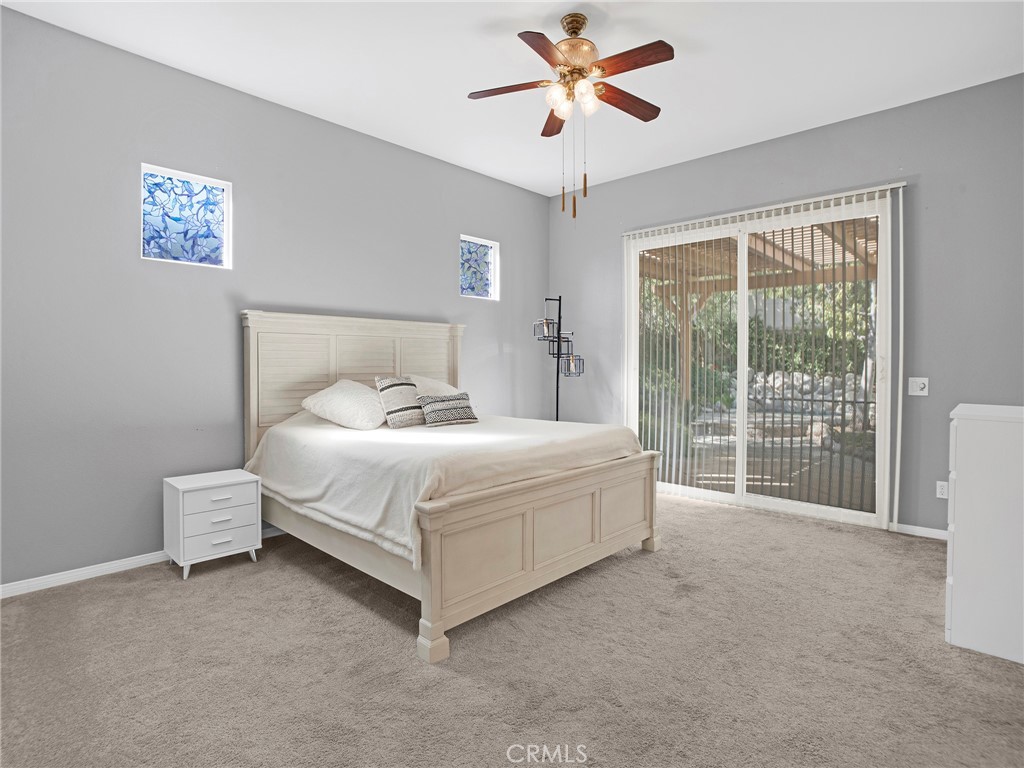 21103 Cross Creek Drive Saugus, CA 91350 - Photo 20 of 41 a bedroom with a bed and a chandelier