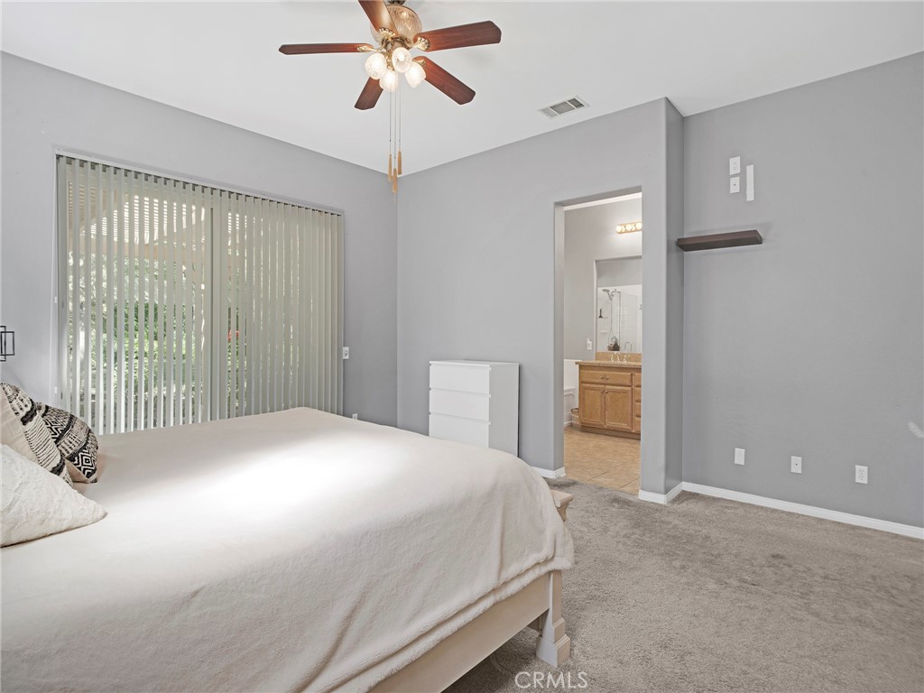 21103 Cross Creek Drive Saugus, CA 91350 - Photo 22 of 41 a bedroom with a bed and a chandelier