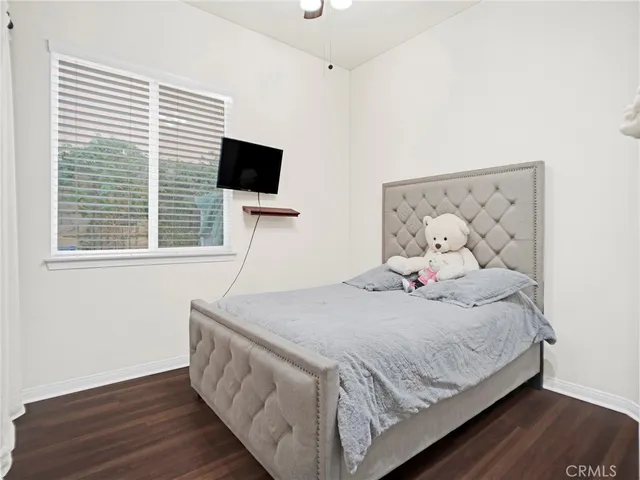 a bedroom with a bed and a desk in it