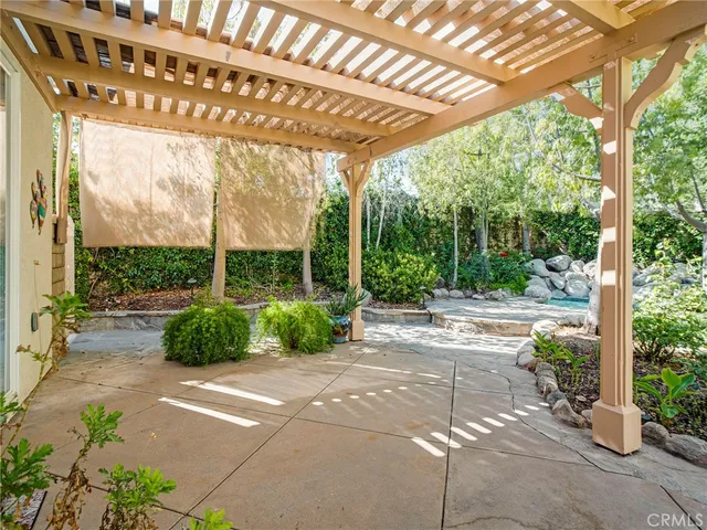 a view of a backyard with plants and a patio