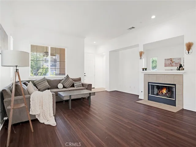 a living room with furniture wooden floor and a fireplace