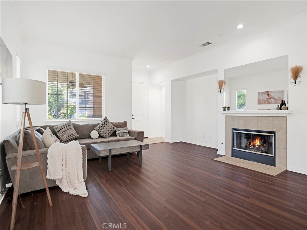 21103 Cross Creek Drive Saugus, CA 91350 - Photo 8 of 41 a living room with furniture wooden floor and a fireplace