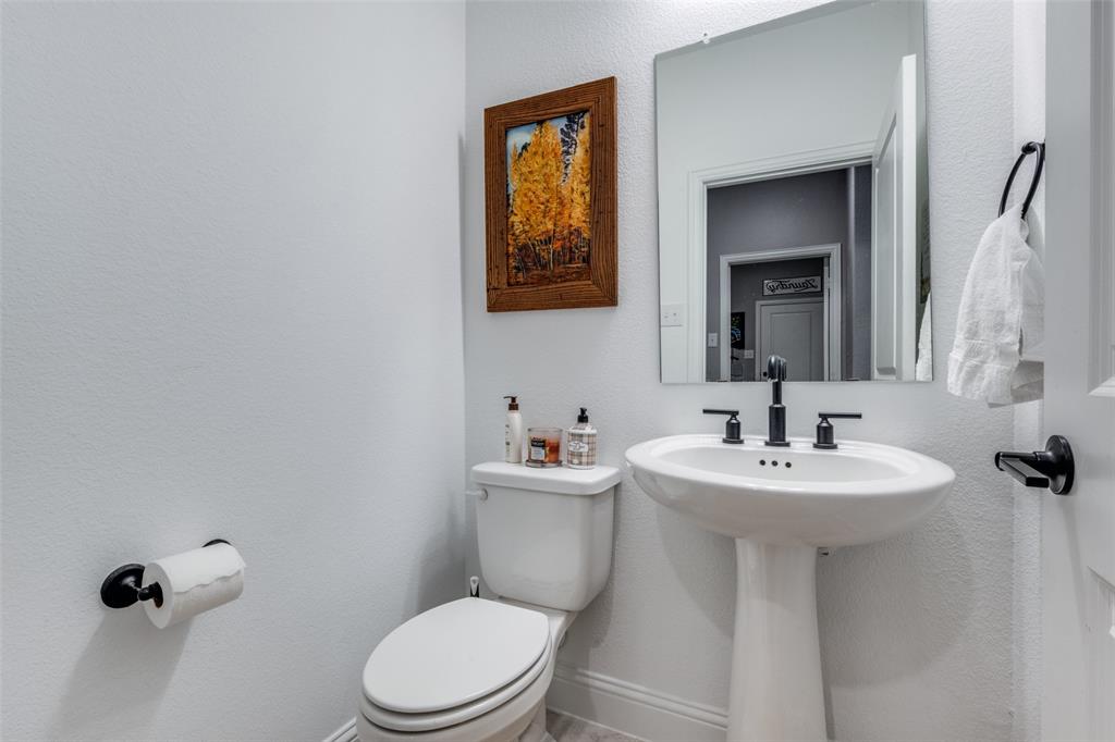 337 Augusta Court Oak Point, TX 75068 - Photo 21 of 26 a bathroom with a toilet sink and mirror