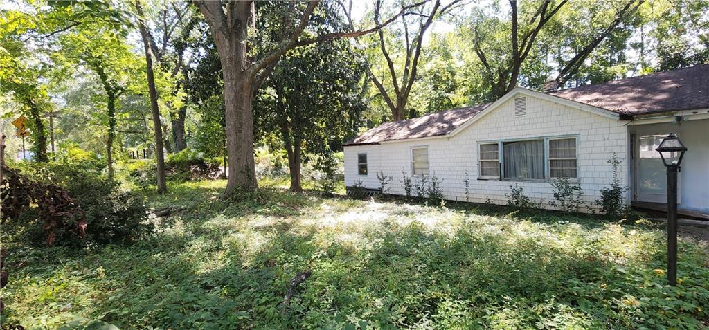 1926 Sumter Street Northwest Atlanta, GA 30318 - Photo 2 of 14 a backyard of a house with yard and outdoor seating