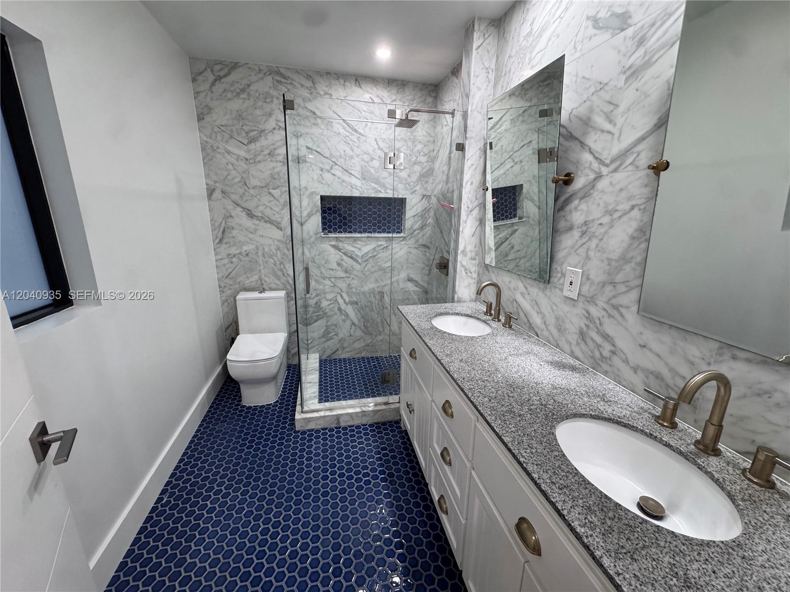375 Southwest 32nd Road Miami, FL 33129 - Photo 32 of 44 a bathroom with a granite countertop double vanity sink mirror and shower