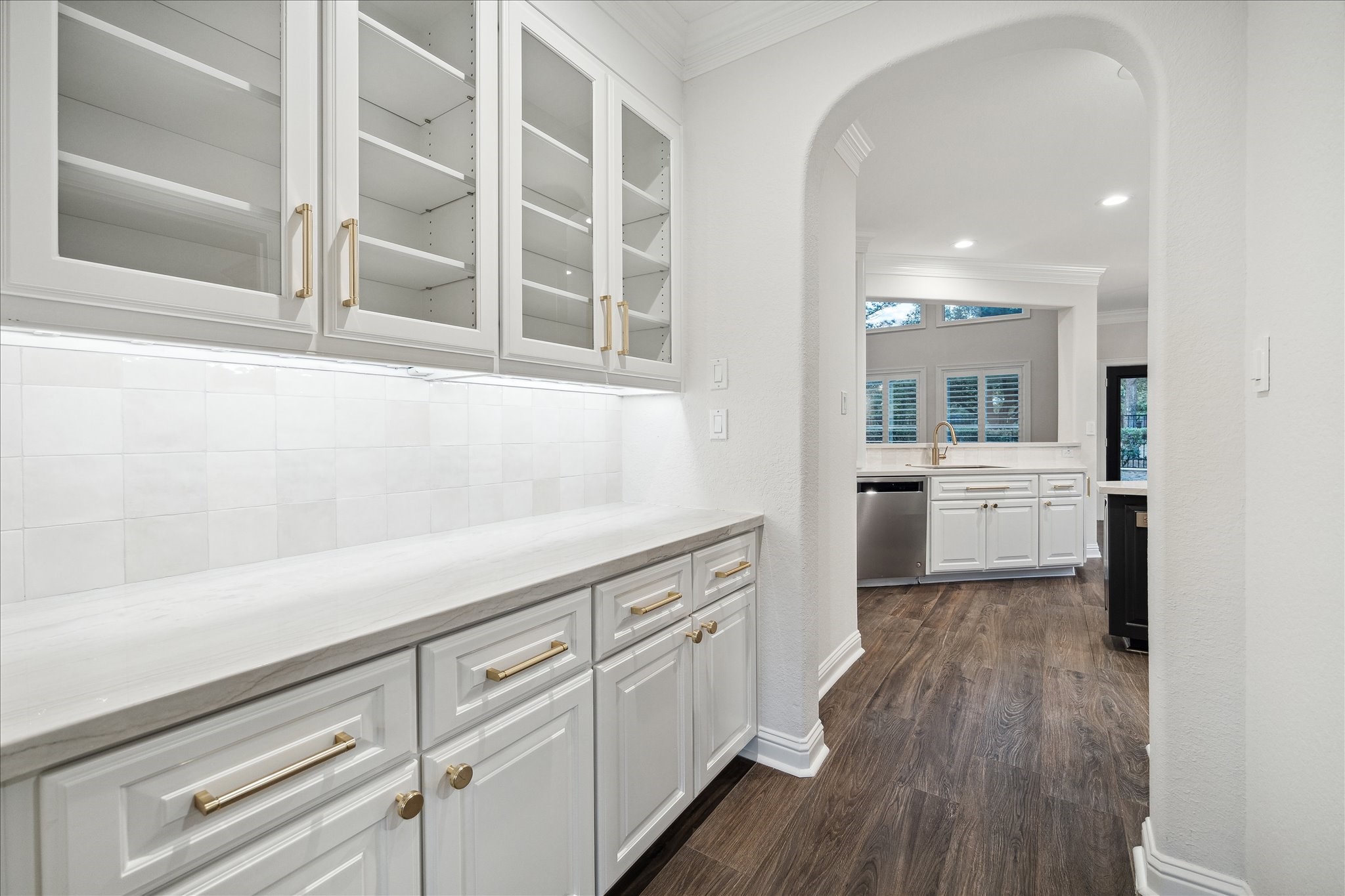 6211 Alameda Point Lane Houston, TX 77041 - Photo 13 of 50 Butler's pantry accessed through the dining area featuring spacious storage, upper cabinets with glass displays, and a seamless connection between the formal dining room and chef's kitchen.