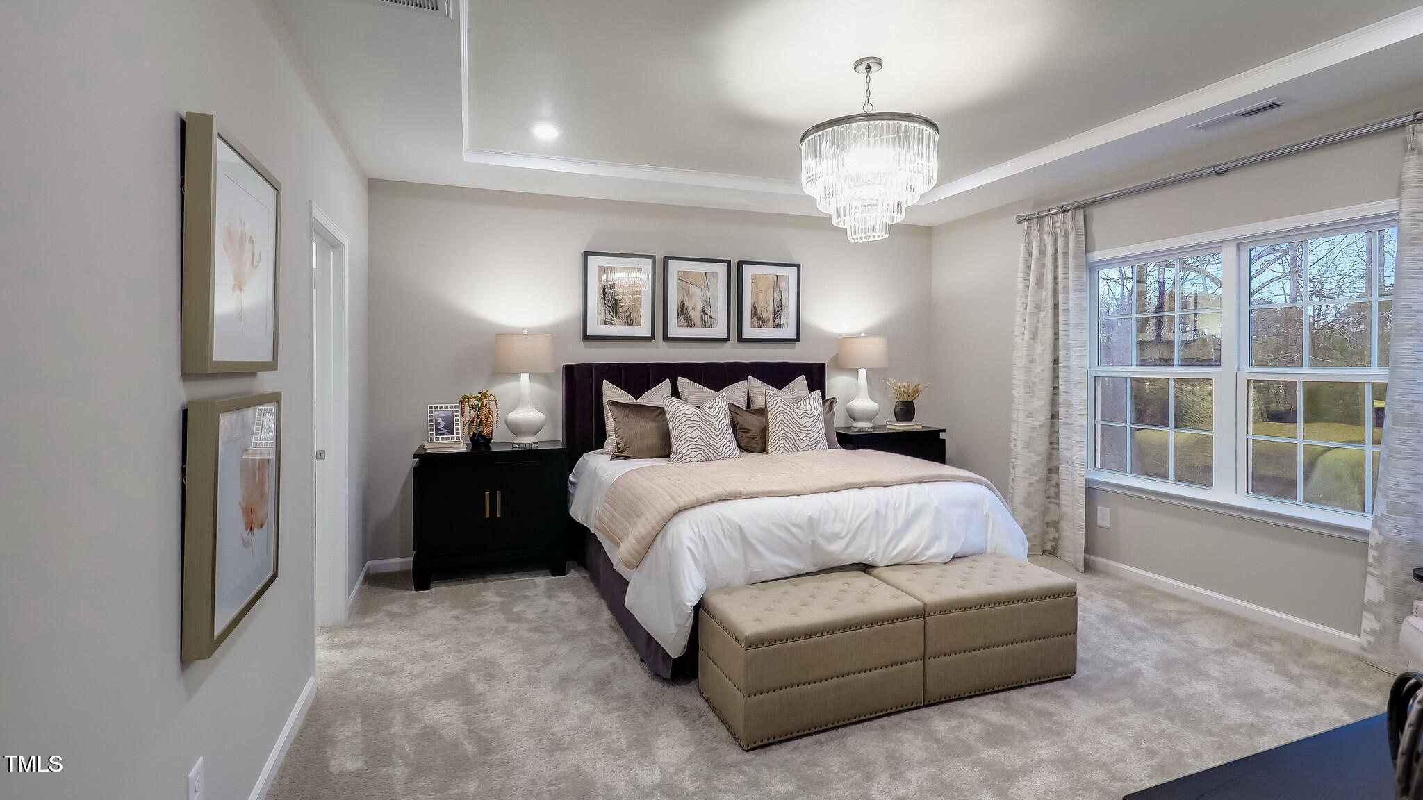 1011 Constellation Circle Durham, NC 27703 - Photo 15 of 25 a bedroom with a large bed and a chandelier