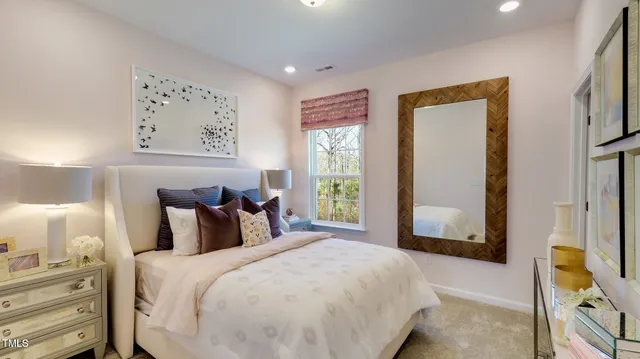 a bedroom with a bed and a large window