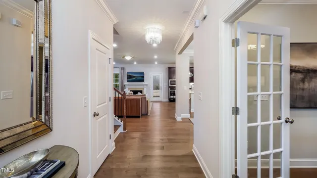 a view of a hallway with dining area and living room