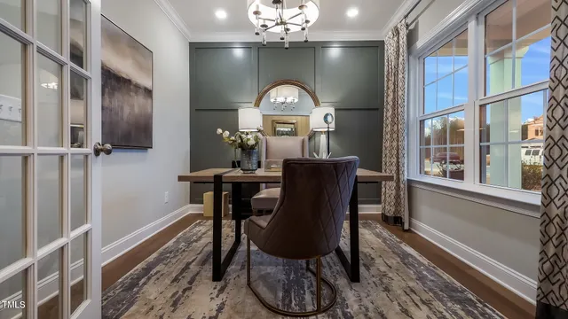 a view of a dining room with furniture a chandelier and wooden floor