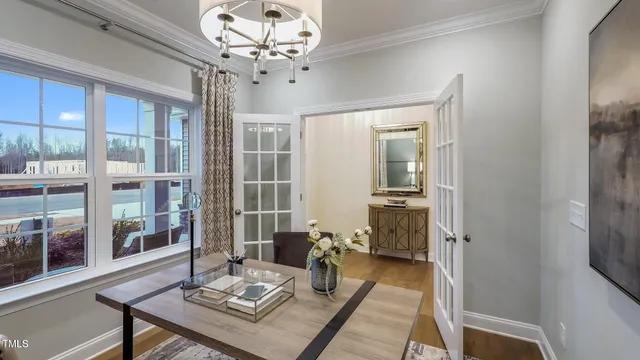 a living room with furniture and a chandelier