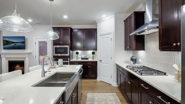 a kitchen with stainless steel appliances a stove sink and microwave