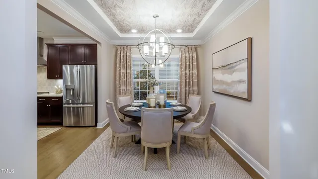 a dining room with furniture a chandelier and window