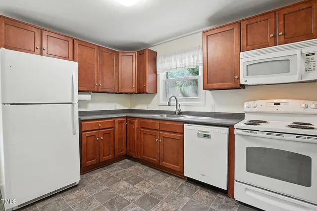 a kitchen with a sink cabinets and window